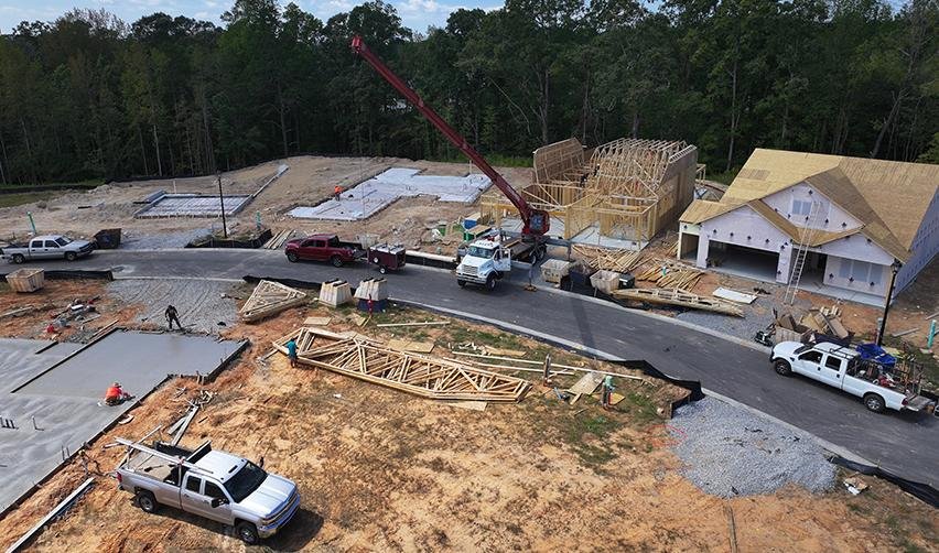 A construction site with trucks and a crane