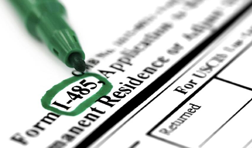 A close up of Form I-485, the petition to adjust status after form i-526 immigrant visa petition approval.