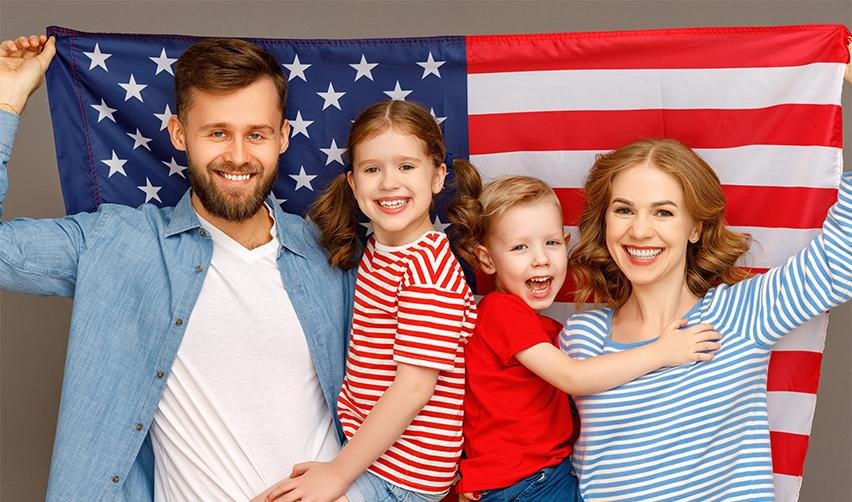 A family of EB5 investors holding the American flag up.