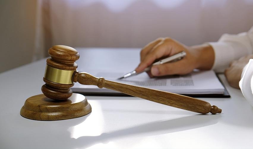 An immigration judge or attorney going over some policy update documents with a gavel on the desk.
