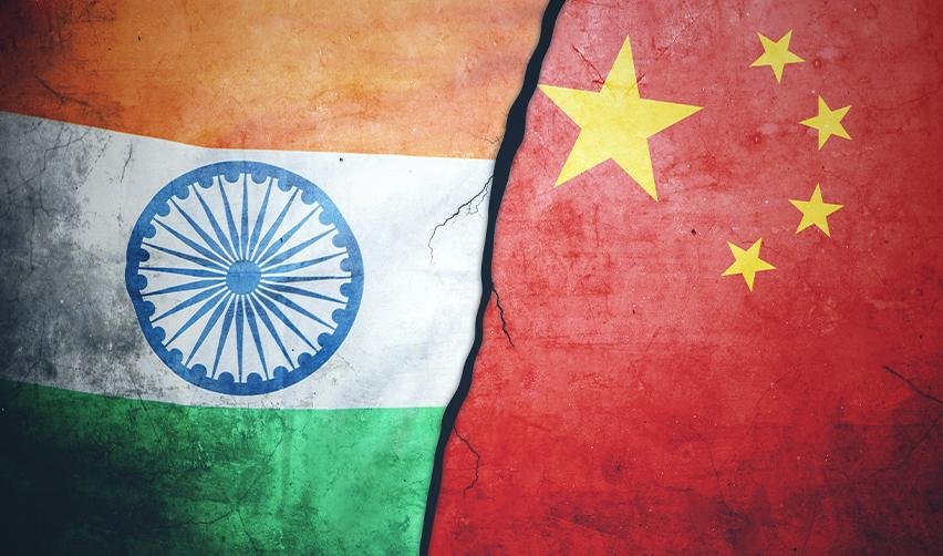 Flags of India and China with a symbolic crack, representing the impact of visa backlogs and retrogression on EB5 investors from these countries.