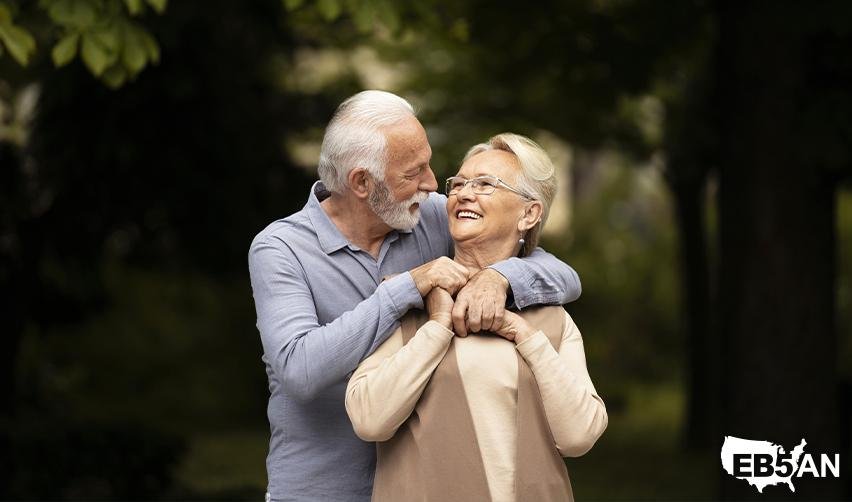 A happy senior couple enjoying outdoor time together with the EB5AN logo on the corner, symbolizing the retirement lifestyle flexibility offered by the EB5 visa.