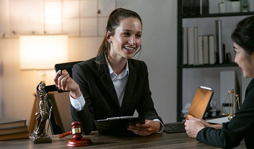 An experienced immigration lawyer smiling during a consultation, emphasizing the importance of selecting the best lawyers for EB5 visa success.