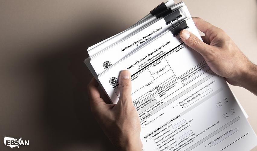 USCIS EB5 visa application forms held by an investor preparing for the EB5 process. Learn about EB5 immigration and investment requirements from EB5AN.