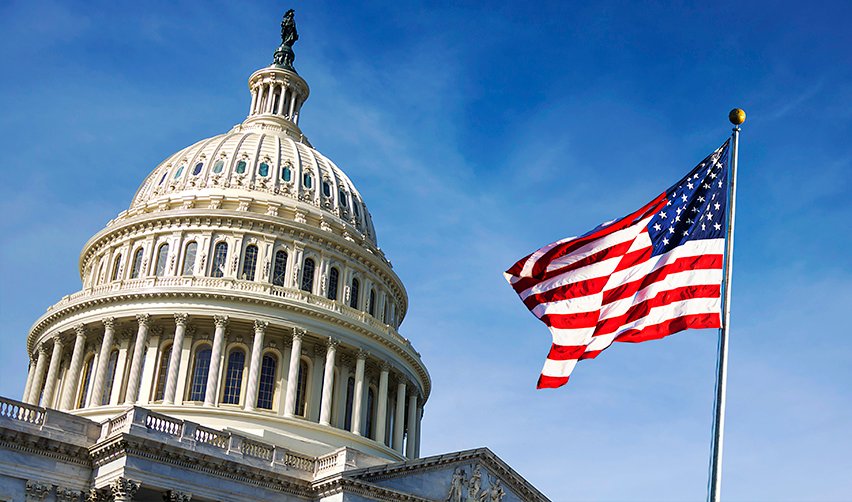 The United States Capitol building with the American flag waving in front, highlighting legislative stability supporting the EB5 immigration program.