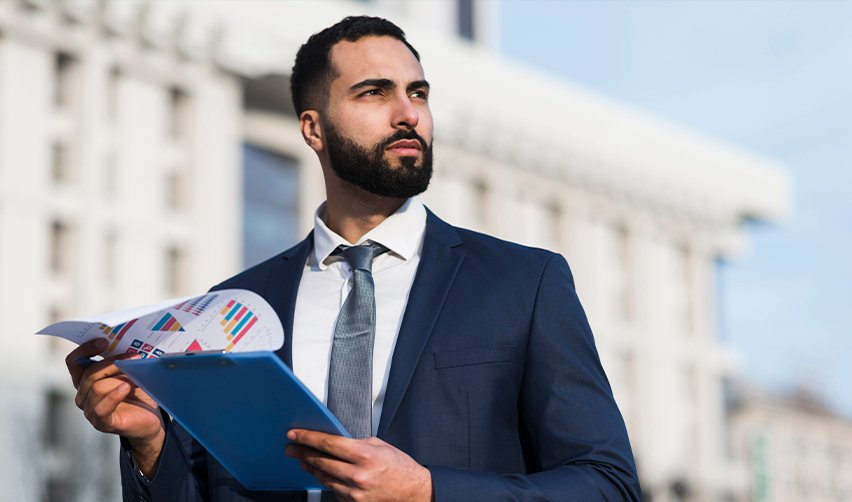 Confident investor reviewing financial charts outdoors, representing global professionals evaluating EB5 investment opportunities.
