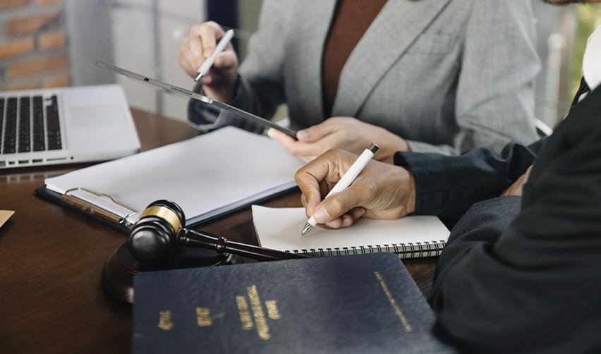 Immigration attorneys and EB5AN experts reviewing EB5 visa travel documents and adjustment of status forms at a law office.
