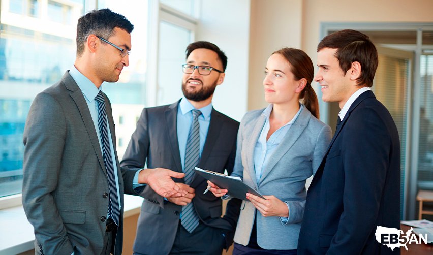 The EB5AN logo next to a business team discussing EB5 investment strategies, evaluating regional center projects, and collaborating with developers for real estate projects.