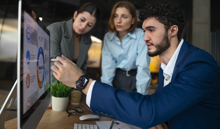 A team reviewing charts on a large screen during a strategy session, depicting experts assessing EB5 regional center performance and risk management options.