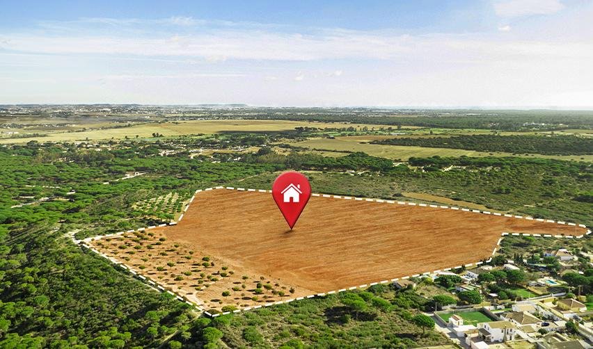 Aerial view of rural land with digital location marker, illustrating EB5 rural TEA investment opportunities available through regional centers.