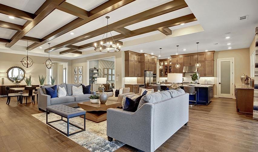 A living room with a kitchen and dining area