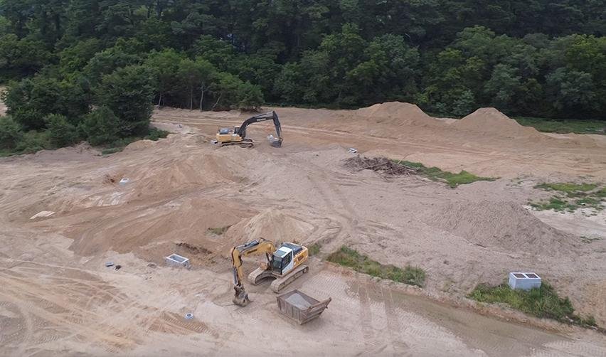 Excavators and earthmoving equipment at Bay Creek construction site, highlighting ongoing infrastructure work for EB5 residential development.