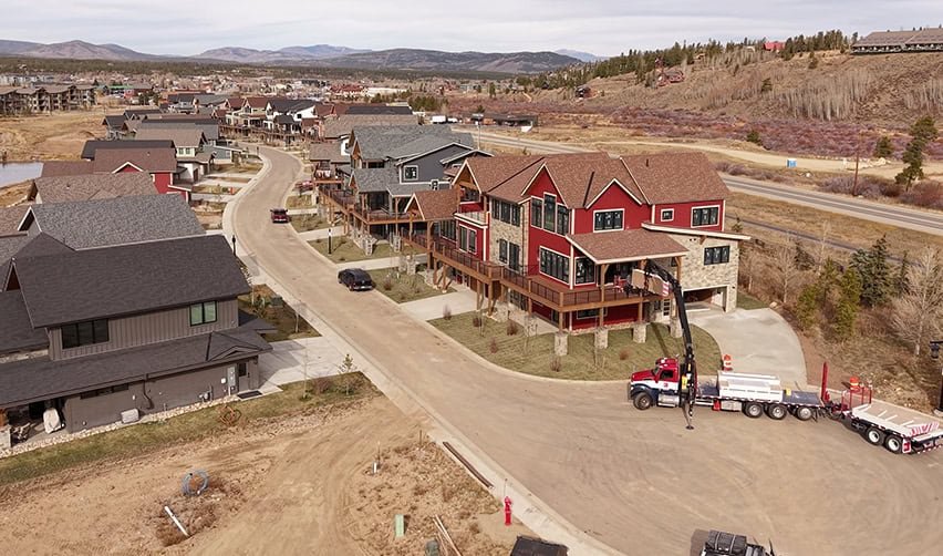 A large red house with a truck parked on the side of it