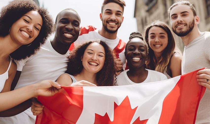 A group of Canadian nationals holding up a Canadian flag.