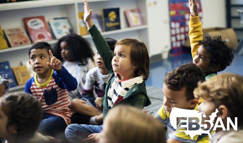 Children of EB5 investors in a classroom, benefiting from U.S. education opportunities, with the EB5AN logo on the corner.
