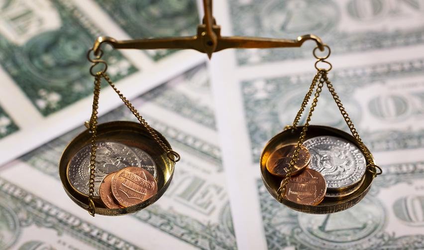 Financial scales representing the funding options for H1B visa holders interested in meeting the EB5 investment requirements for U.S. permanent residency.