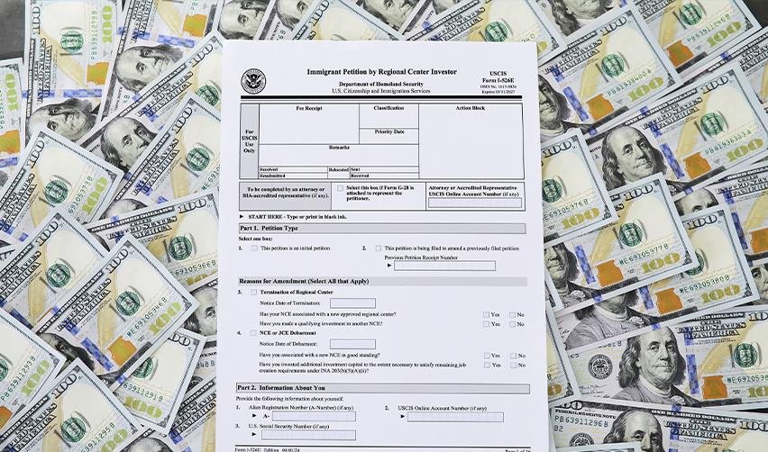 Form I-526E for EB5 immigrant investors placed on a background of U.S. dollar bills, representing investment requirements and funding for U.S. Green Card applications.