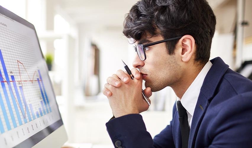 Focused EB5 applicant evaluating immigration risk and processing time trends through data charts, representing the shift toward rural visa category strategies.