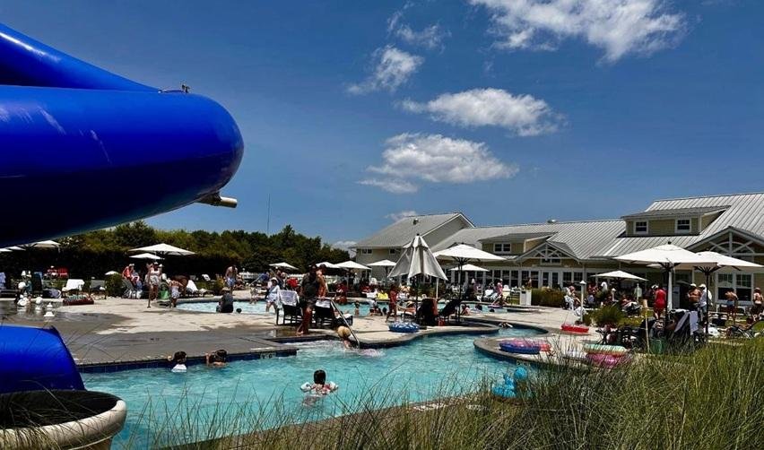 A wide angle shot of a fun day at the pool for residents and guests at the Bay Creek resort and EB5 rural TEA project in Cape Charles, Virginia.