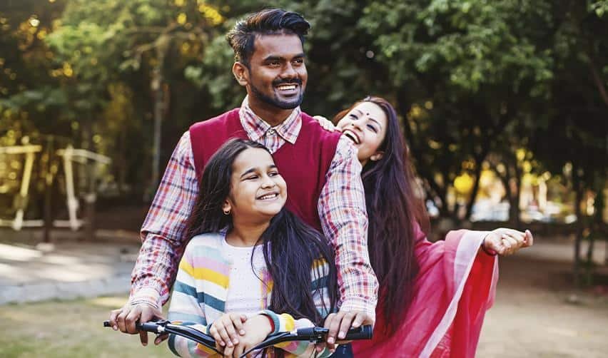 An Indian family enjoying time together in a park, representing the freedom and stability EB5 investors gain after moving to the United States.